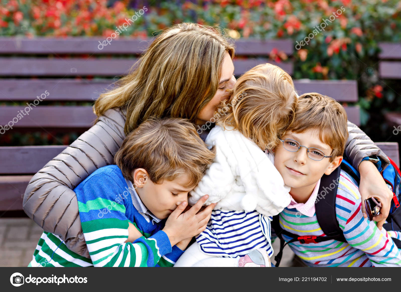 Mutter Und Drei Kinder Umarmen Sich. Glückliche Familie Sitzt Draußen bei Bilder Kinder Umarmen Sich