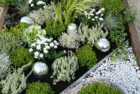 A Garden With Gravel, Rocks And Plants In The Center Is Displayed On An bei Grabbepflanzung Sommer Einzelgrab